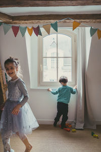 Girl and boy playing at home