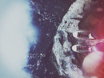 Low section of woman against sea