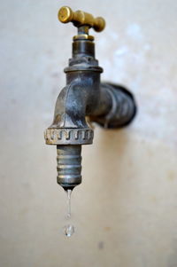 Close-up of water drop from faucet