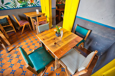 High angle view of empty chairs and table in restaurant