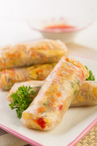 Close-up of spring rolls served in tray