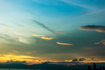 Low angle view of silhouette mountain against dramatic sky