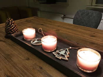 Close-up of tea light candle on table at home