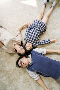 High angle view of family relaxing on floor at home