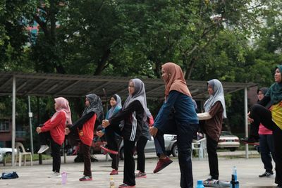 Rear view of people walking outdoors