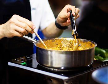 Midsection of man preparing food in kitchen