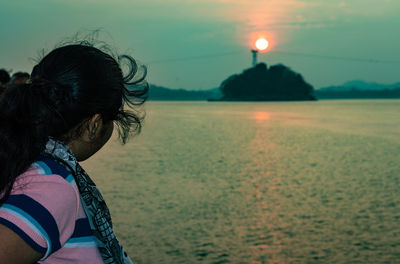 Rear view of woman looking at sea against sky