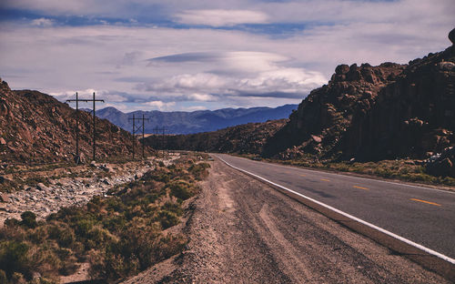 Road amidst mountains against sky
