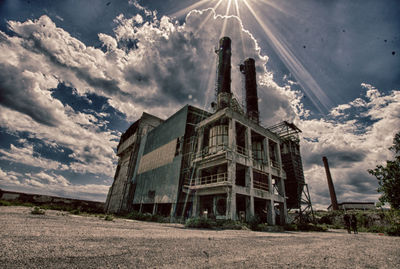 Low angle view of abandoned building against sky