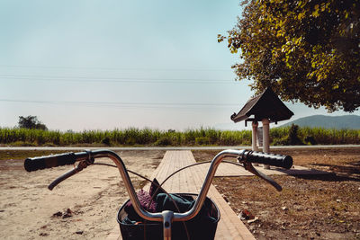 Bicycle on field against clear sky