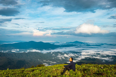 Man standing on mountain against sky