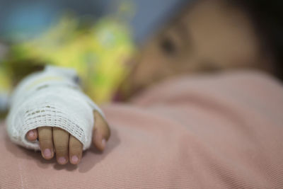 Low section of woman sleeping on bed