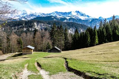 Scenic view of field and mountains against sky