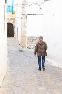 Full length rear view of man walking on street