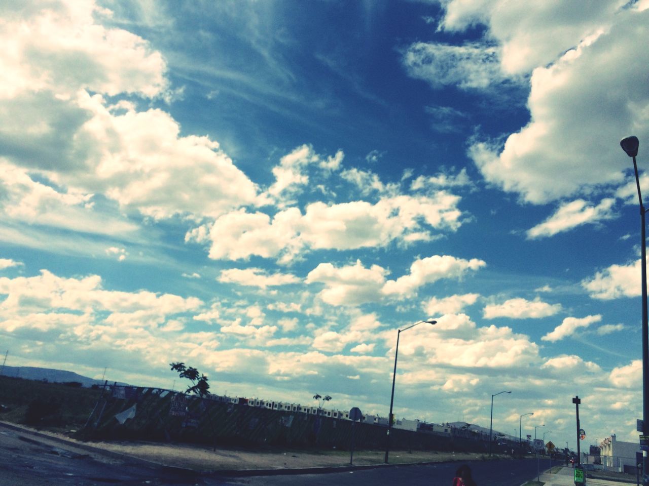 sky, cloud - sky, cloudy, road, transportation, street light, cloud, the way forward, tranquility, tranquil scene, scenics, nature, blue, beauty in nature, landscape, street, outdoors, no people, diminishing perspective, car