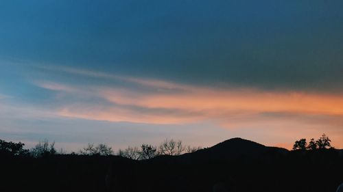 Silhouette landscape against sky during sunset