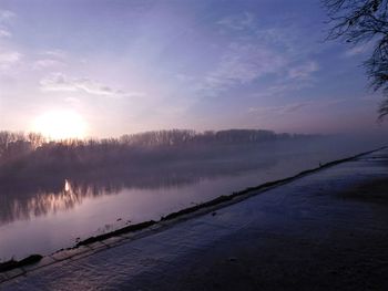 Scenic view of calm lake at sunset