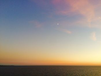 Scenic view of sea against sky at sunset