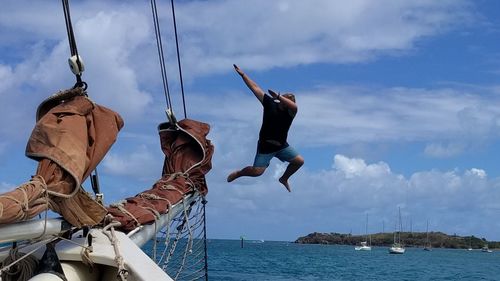 Man jumping into sea from a boat