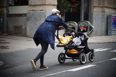 Rear view of man walking on road