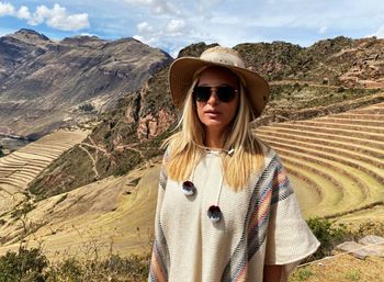 Portrait of woman wearing sunglasses while standing on mountain