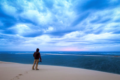 Full length of woman on beach against sky