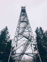 Low angle view of communications tower against sky