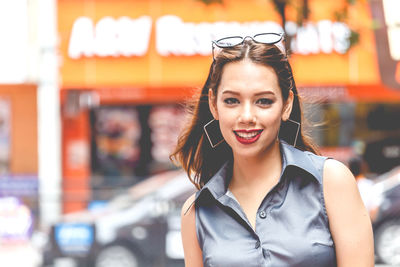 Close-up portrait of happy young woman in city