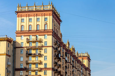 Low angle view of buildings against clear blue sky