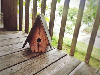 Close-up of birdhouse on wooden deck