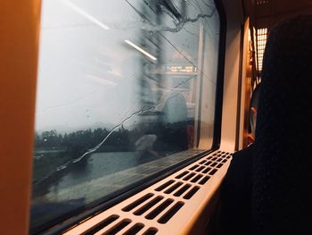 Reflection of man on glass window in train