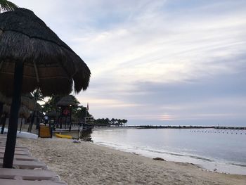 Scenic view of beach against sky during sunset