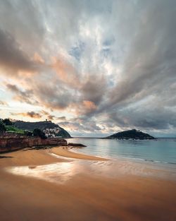 Scenic view of beach against sky during sunset