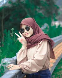 Young woman wearing sunglasses while standing outdoors