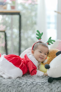 Portrait of smiling boy lying in toy at home