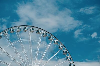 Low angle view of ferris wheel against blue sky