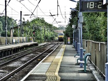 Train at railroad station against sky