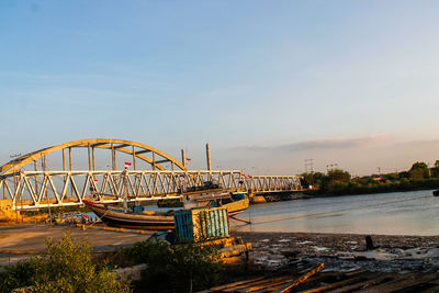 View of bridge over river against cloudy sky