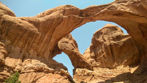 Low angle view of double arch at arches national park