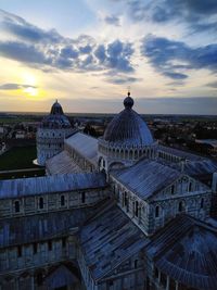 Temple in building against sky during sunset