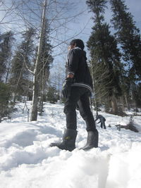 Full length of man standing on snow covered landscape