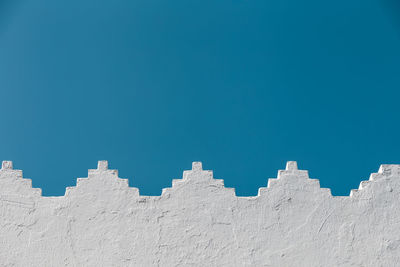 Low angle view of building against clear blue sky