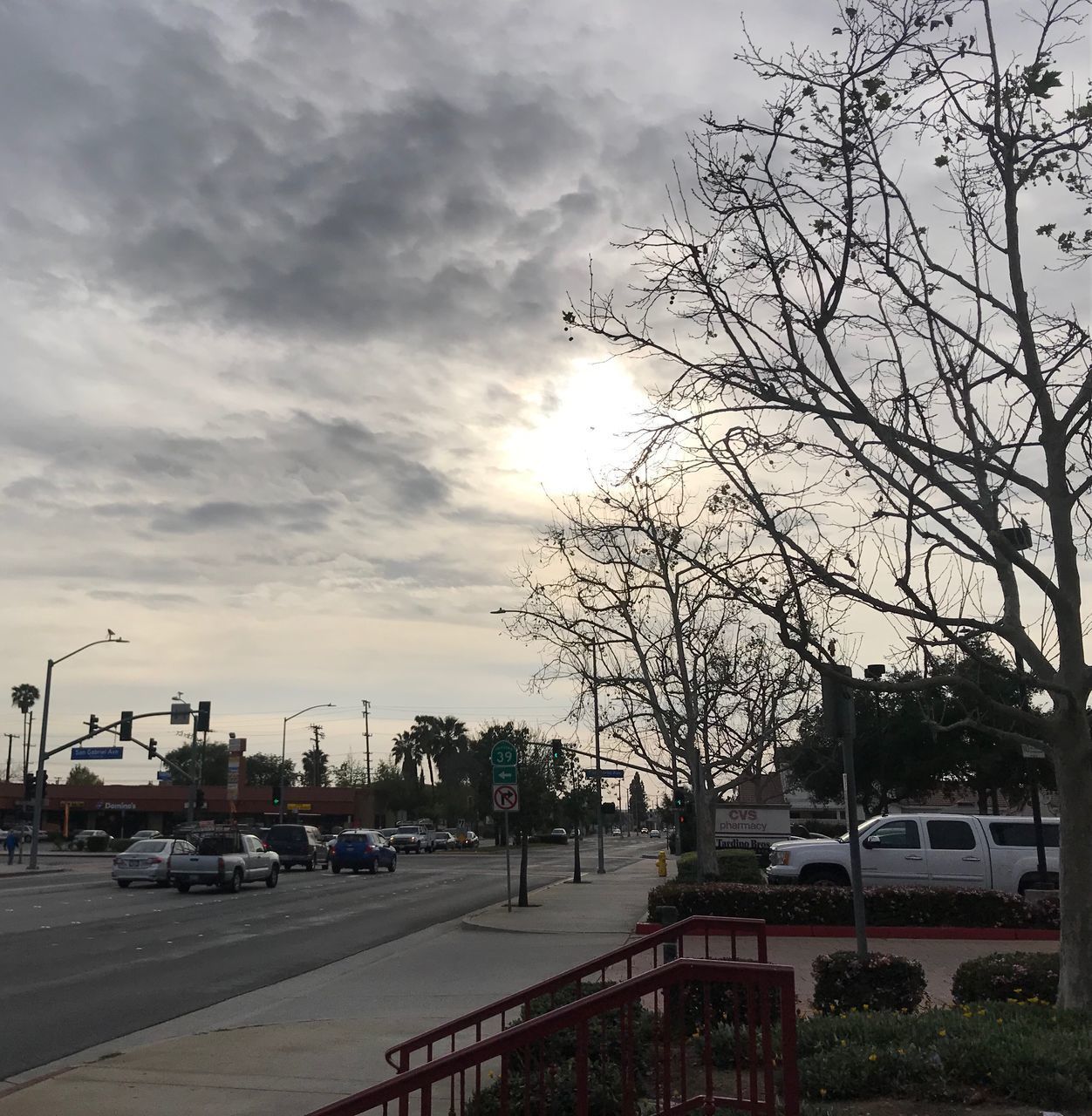 CARS ON STREET IN CITY AGAINST SKY