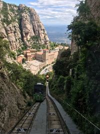 High angle view of railroad tracks by mountain against sky