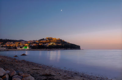 Scenic view of sea against clear sky during sunset