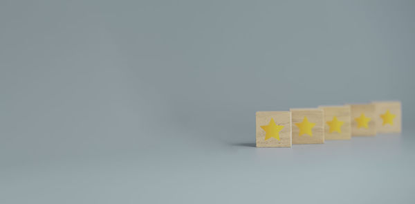 Close-up of yellow toy on table against white background