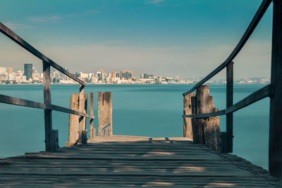 Pier over sea against blue sky