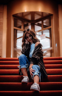 Portrait of woman sitting on staircase