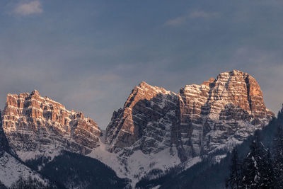 Panoramic view of rocky mountains against sky during winter