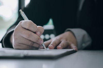 Close-up of man working on table